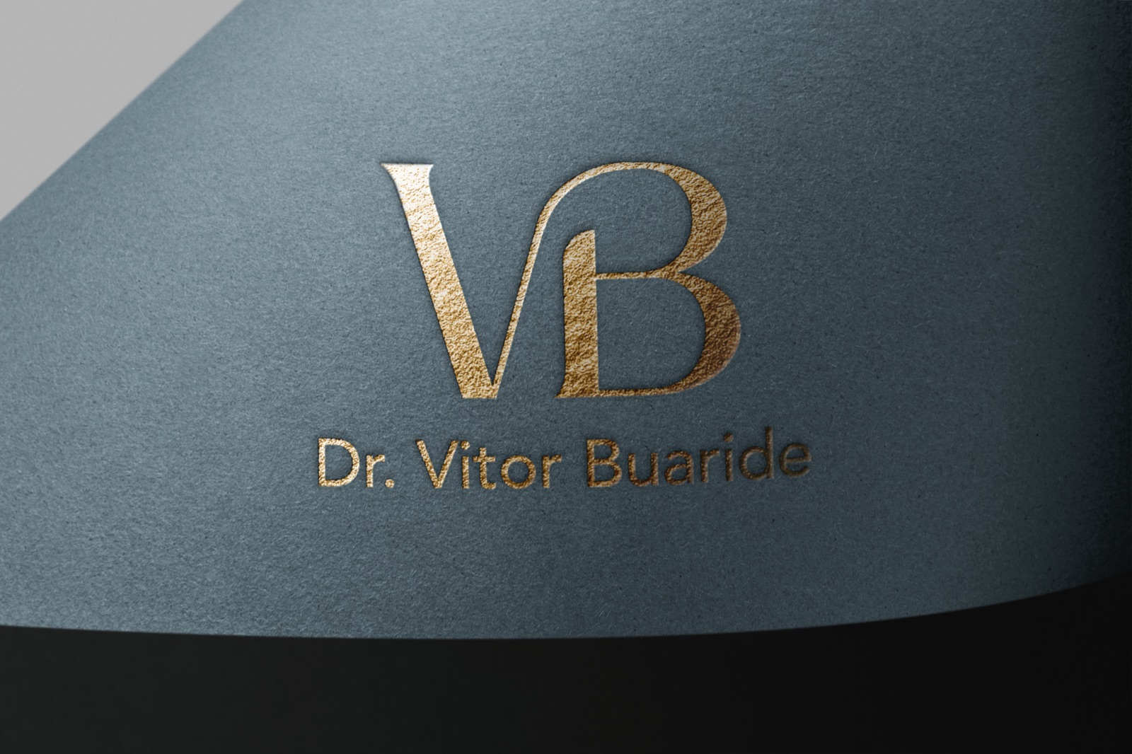 VB monogram in gold hot stamping on textured blue-gray paper